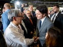 Honda chief executive Toshihiro Mibe shakes hands with Prime Minister Justin Trudeau at an event to announce a new EV battery and automotive assembly plant in Alliston, Ont., on April 25, 2024. 