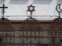 The symbols of the three monotheistic religions, Christianity, Judaism and Islam, on the front of an Arab-Jewish centre in the northern port city of Haifa in Israel, in 2016. 