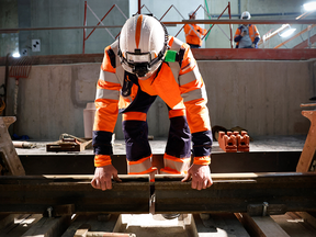 A worker prepares a rail for welding
