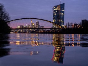 FILE - The European Central Bank is reflected in the river Main in Frankfurt, Germany, Thursday, March 21, 2024. The inflation that has squeezed European shoppers fell more than expected in March to 2.4%, as cost spikes in the grocery aisle eased and overall price rises headed down in the two biggest economies, Germany and France.