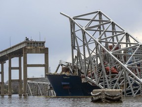 The site of the collapsed Francis Scott Key Bridge and the container ship that toppled it, Dali, are seen from a debris retrieval vessel, the Reynolds, April 4, 2024.