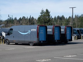 Electric vans are parked at the Amazon Delivery Station in Maple Valley, Washington.