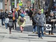 Pedestrians walk down St. Catherine Street in Montreal.