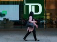 A person walks past a Toronto-Dominion Bank sign in the financial district in Toronto.