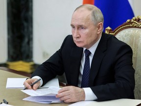 Russia's President Vladimir Putin chairs a meeting with local Russian authorities in Moscow.