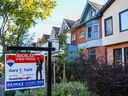 A for sale sign is posted in front of a home in Toronto's Riverdale neighborhood.