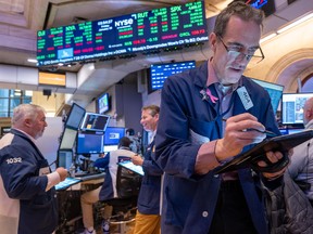 Traders work on the floor of the New York Stock Exchange in New York City.