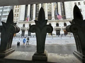 The New York Stock Exchange is seen, through a window guard, on Tuesday, April 16, 2024 in New York. Wall Street drifted toward gains as more corporate earnings come in, giving investors a break from fretting about if and when the Federal Reserve might cut interest rates.