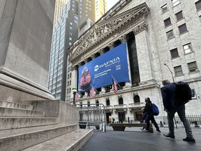 People walk past the New York Stock Exchange Tuesday, April 9, 2024 in New York.European equities have dipped in early trading while Asian stocks closed mostly higher, with investors mainly focusing on a U.S. inflation report and what it means for interest rate cuts by the Federal Reserve.