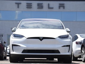 FILE - An Unsold 2023 Model X sports-utility vehicle sits outside a Tesla dealership Sunday, June 18, 2023, in Englewood, Colo. Tesla sales are expected to fall in the first quarter as demand for electric vehicles continues to slow.