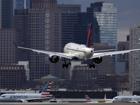 FILE - A Delta Air Lines plane lands at Logan International Airport, Jan. 26, 2023, in Boston. Delta reports earnings on Wednesday, April 10, 2024.
