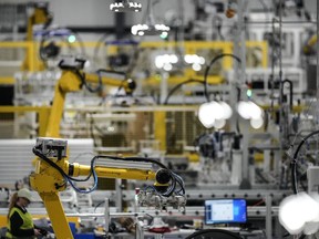 FILE - Articulated robots move inside the Hanwha Qcells Solar plant, Oct. 16, 2023, in Dalton, Ga. On Thursday, April 25, 2024, the U.S. government issues the first of three estimates of economic growth in the first quarter.