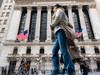 People walk past the New York Stock Exchange (NYSE) on April 10, 2024 in New York City