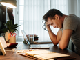 A sad young man sitting at his computer