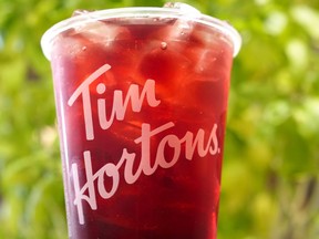 The owner of Tim Hortons and Burger King says it first-quarter profit rose compared with a year earlier as its sales also climbed higher. A blackberry yuzu sparkling quencher is photographed at the Tim Hortons test kitchen in Toronto, Friday, Dec. 8, 2023.