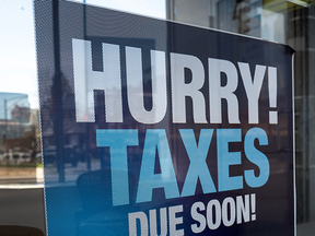 Sign in storefront saying taxes due soon