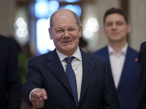 FILE - German Chancellor Olaf Scholz gestures as he arrives at the Party of European Socialists (PES) Leaders Conference, at the Palace of the Parliament, the second largest administrative building in the world after the Pentagon, in Bucharest, Romania, on April 6, 2024. Scholz arrived in China on Sunday, April 14, 2024 on a visit focused on the increasingly tense economic relationship between the sides and differences over Russia's invasion of Ukraine.