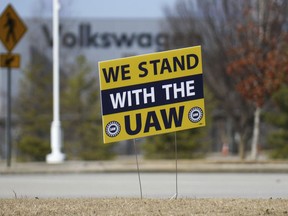 FILE - A "We stand with the UAW" sign appears outside of the Volkswagen plant in Chattanooga, Tenn., on Dec. 18, 2023. Workers at at the Tennessee factory are scheduled to finish voting Friday, April 19, 2024, on whether they want to be represented by the United Auto Workers union.