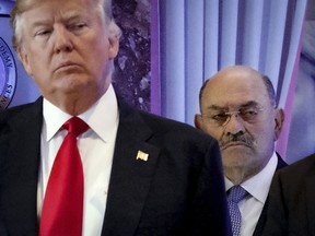 FILE - Allen Weisselberg, right, stands behind then President-elect Donald Trump during a news conference in the lobby of Trump Tower in New York, Jan. 11, 2017. Weisselberg, a former longtime executive in Donald Trump's real estate empire, is set to be sentenced for lying under oath in the ex-president's New York civil fraud case. Weisselberg is expected to be sentenced Wednesday to five months in jail after pleading guilty last month to two counts of perjury.