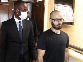 Tigran Gambaryan, an American citizen and Binance's head of financial crime compliance, right, is escorted as he leaves a court hearing at the federal High Courts, in Abuja, Nigeria, Thursday, April 4, 2024.