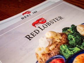 In this photo illustration, a menu is displayed on a plate at a Red Lobster restaurant on May 20, 2024 in Austin, Texas.