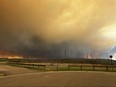 Smoke and flames from the fire in Fort McMurray, Alta., on May 14 as residents from Abasand Heights evacuate the area.