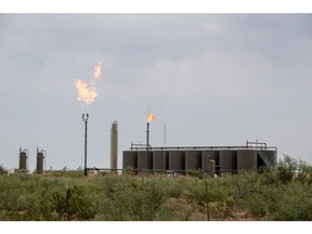 Methane gas is flared just off U.S. Route 285 near Carlsbad, New Mexico, U.S., on Tuesday, Aug. 6. 2019. New Mexico's Governor Michelle Lujan Grisham is balancing her concern over the catastrophic effects of climate change with the state's extraordinary dependence on oil and gas. Photographer: Steven St John/Bloomberg