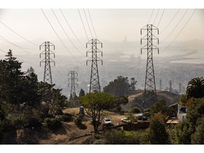 Power transmission lines above homes in the Oakland Hills area of Oakland, California, U.S., on Thursday, Oct. 29, 2020. An increasing amount of Californians have been dropped by their regular insurers after years of devastating wildfires that cost billions of dollars and upended the market.