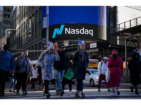 Pedestrians pass the Nasdaq MarketSite in New York, US, on Tuesday, Jan. 2, 2024. The Nasdaq index slid 1.6% in the tech-heavy benchmark's biggest drop in about a month as Apple fell after an analyst at Barclays Plc warned that iPhone demand is cooling. Photographer: Michael Nagle/Bloomberg