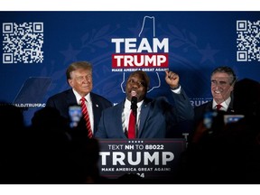 Senator Tim Scott, a Republican from South Carolina, center, speaks during a campaign event with former US President Donald Trump, left, and Doug Burgum, governor of North Dakota, right, in Laconia, New Hampshire in January.