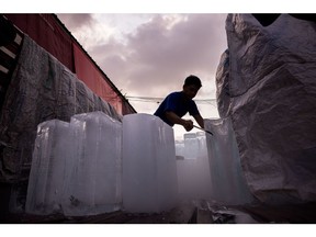 A man unloads blocks of ice from a truck during high temperatures in Bangkok, Thailand, on Sunday, April 28, 2024. Southeast Asia's second-largest economy has been bracing for hotter-than-normal days due to the El Nino weather pattern that's forecast to last until June.
