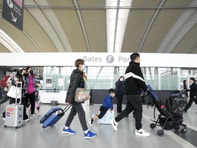 People walk through Pearson International Airport