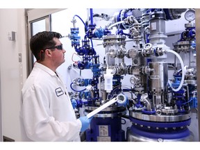 Researcher checking process parameters at the new cutting-edge CGMP Kilolab line, located at Dipharma Inc., in Kalamazoo MI, USA