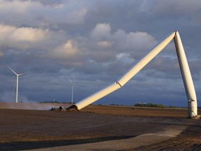 The remains of a tornado-damaged wind turbine touch the ground in a field, Tuesday, May 21, 2024, near Prescott, Iowa.