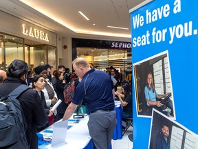 Job seekers attend a jobs fair in London, Ontario last month. Canada's economy gained 90,000 jobs in April.