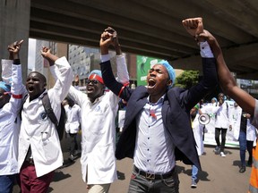 FILE - Doctors and other medical staff take part in a protest, in downtown Nairobi, Kenya, Tuesday, April 16, 2024. Kenya's public hospital doctors union on Wednesday, May 8, 2024, signed a return to work agreement with the government, ending a national strike that began in mid-March and had left patients in limbo.