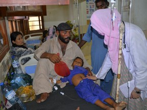 FILE - A doctor checks a child, who is suffering from gastroenteritis due to hot weather, at a hospital in Hyderabad, Pakistan, on May 23, 2024. A new study by the United Nations children's agency released on Friday May 31, 2024 says developing resilient energy systems to power health facilities in Pakistan could avert over 175,000 deaths by 2030.