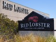 FILE - Signs for a Red Lobster restaurant are shown in San Bruno, Calif., Tuesday, May 14, 2024. Red Lobster has filed for Chapter 11 bankruptcy protection days after shuttering dozens of restaurants. The seafood chain has been struggling for some time with lease and labor costs piling up in recent years and also promotions like its iconic all-you-can-eat shrimp deal.
