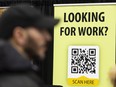 A person walks by a QR code at a National Career Event job and continuing education fair in Montreal.