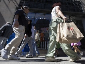 A shopper carries an H&M bag in downtown Montreal, Que.