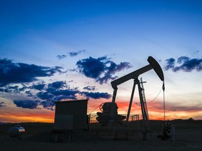 A pumpjack draws out oil from a wellhead near Calgary.