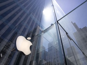 FILE - In this June 16, 2020 file photo, the sun is reflected on Apple's Fifth Avenue store in New York. Apple will reports earnings on Thursday May 2, 2024.