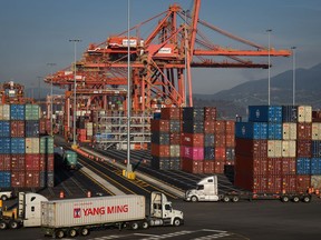 Statistics Canada says the country posted a merchandise trade deficit of $2.3 billion in March. A truck carries a cargo container at the Port of Vancouver Centerm container terminal in Vancouver, on Friday, October 14, 2022.
