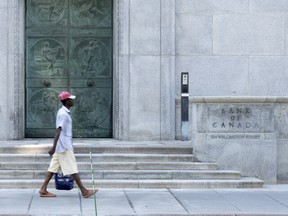 A man walks past the Bank of Canada building on Sept. 6, 2023 in Ottawa.