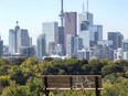 A park bench with graffiti overlooking the downtown skyline along Broadview Ave. in Toronto, Ont. on Oct. 5, 2022.