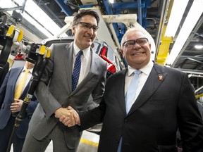 Prime Minister Justin Trudeau shakes hands with Ontario Premier Doug Ford during an event at the Honda of Canada Manufacturing Plant 2 in Alliston, Ontario, on April 25, 2024.