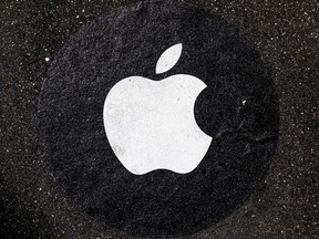 An Apple Inc. logo used as a distance marker on the pavement in front of a store in San Francisco, Calif., on April 26, 2021.