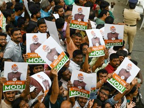 Supporters await the arrival of India's Prime Minister Narendra Modi at a road show as part of Bharatiya Janata Party's (BJP) election campaign ahead of the national elections in Hyderabad on March 15, 2024.