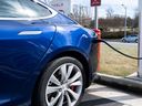 A Tesla Model S sedan is plugged into a Tesla Supercharger electric vehicle charging station in Falls Church, Virginia, on February 13, 2023.
