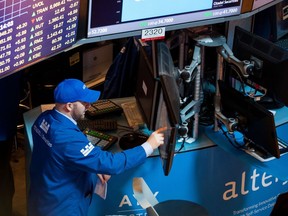 A trader works on the floor of the New York Stock Exchange (NYSE) during the Alteryx Inc. initial public offering (IPO) in New York, U.S., on Friday, March 24, 2017.